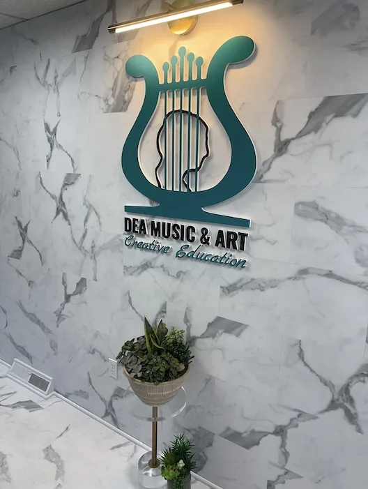DEA Music and Art logo on the Morristown studio wall